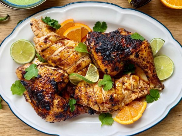 Whole roasted spatchcock Pollo Asado with crispy skin served with soft tortillas.